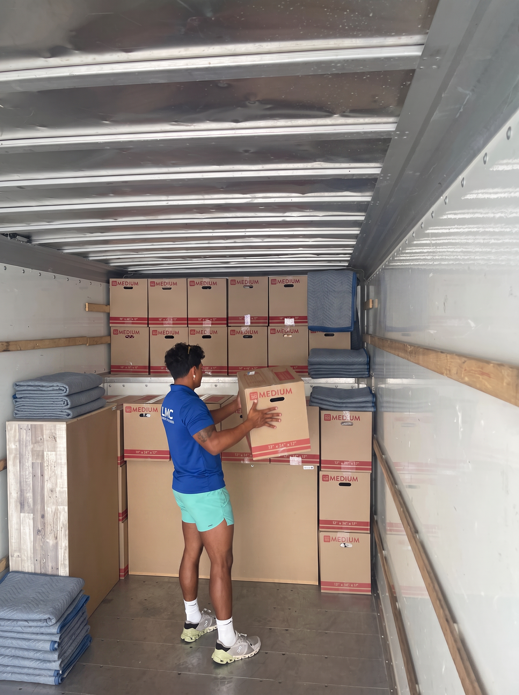 LMC crew member stacking boxes inside a moving truck