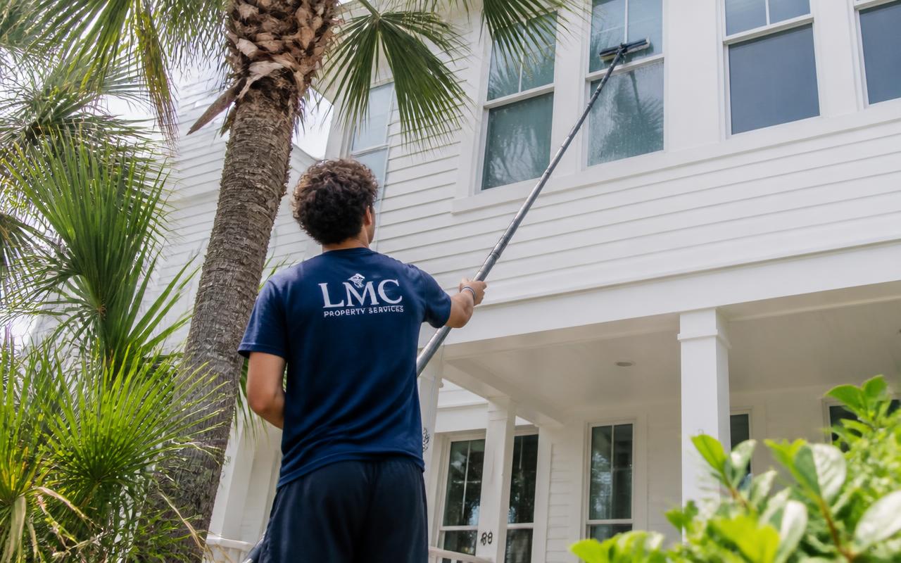 LMC crew water-fed pole window cleaning at a Gulf Coast beach house